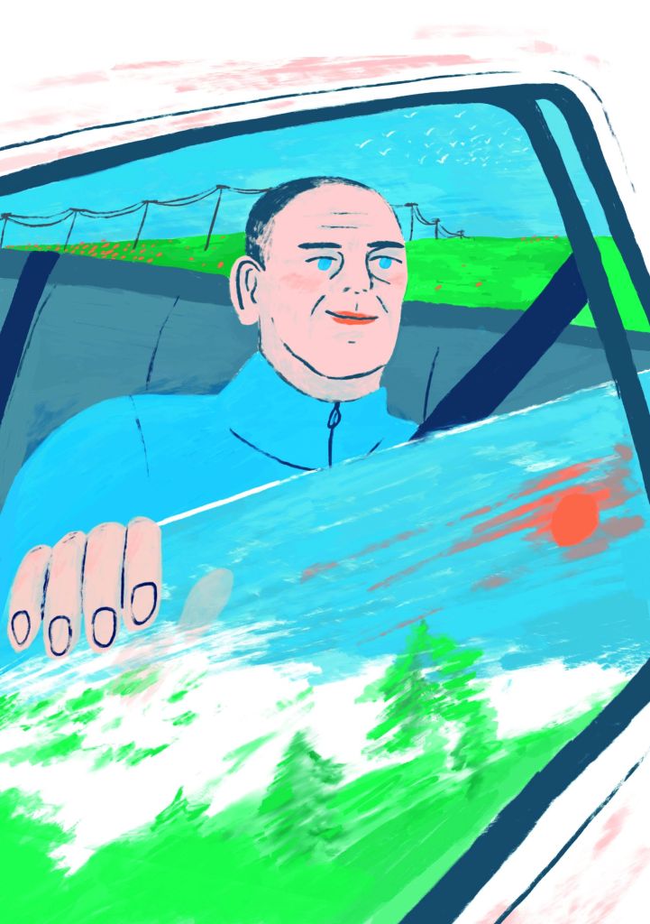 Un homme installé à l'arrière d'une voiture regarde le paysage à travers la vitre baissée